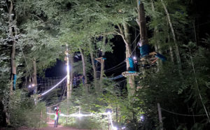accrobrance nocturne éclairé par des guirlandes